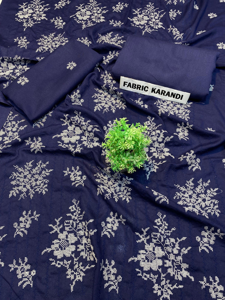 The black fabric adorned with white floral embroidery is presented, highlighted by a small green plant at its center. In the upper right corner, a label reveals "Regal Hues Bareeze" from ESHMEEN's Winter Collection, emphasizing its premium quality.