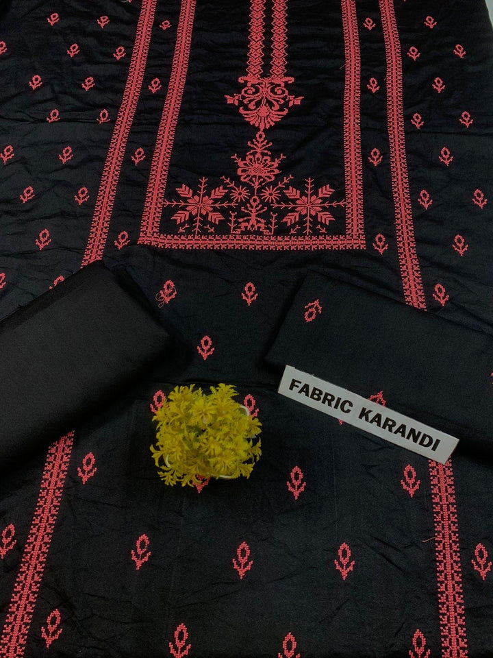 Regal Dusk Bareeze from ESHMEEN showcases beautifully intricate blue patterns on purple fabric, with two artfully folded pieces labeled as part of the Winter Collection. A small yellow bouquet is elegantly placed at the center on this premium quality fabric.